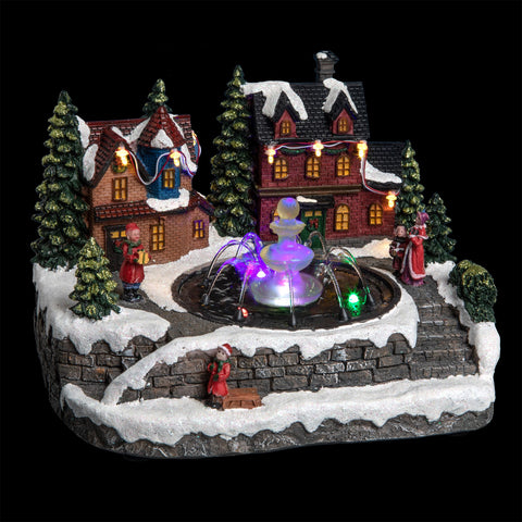 Pueblo Navideño Luminoso con Casas y Fuente de Agua